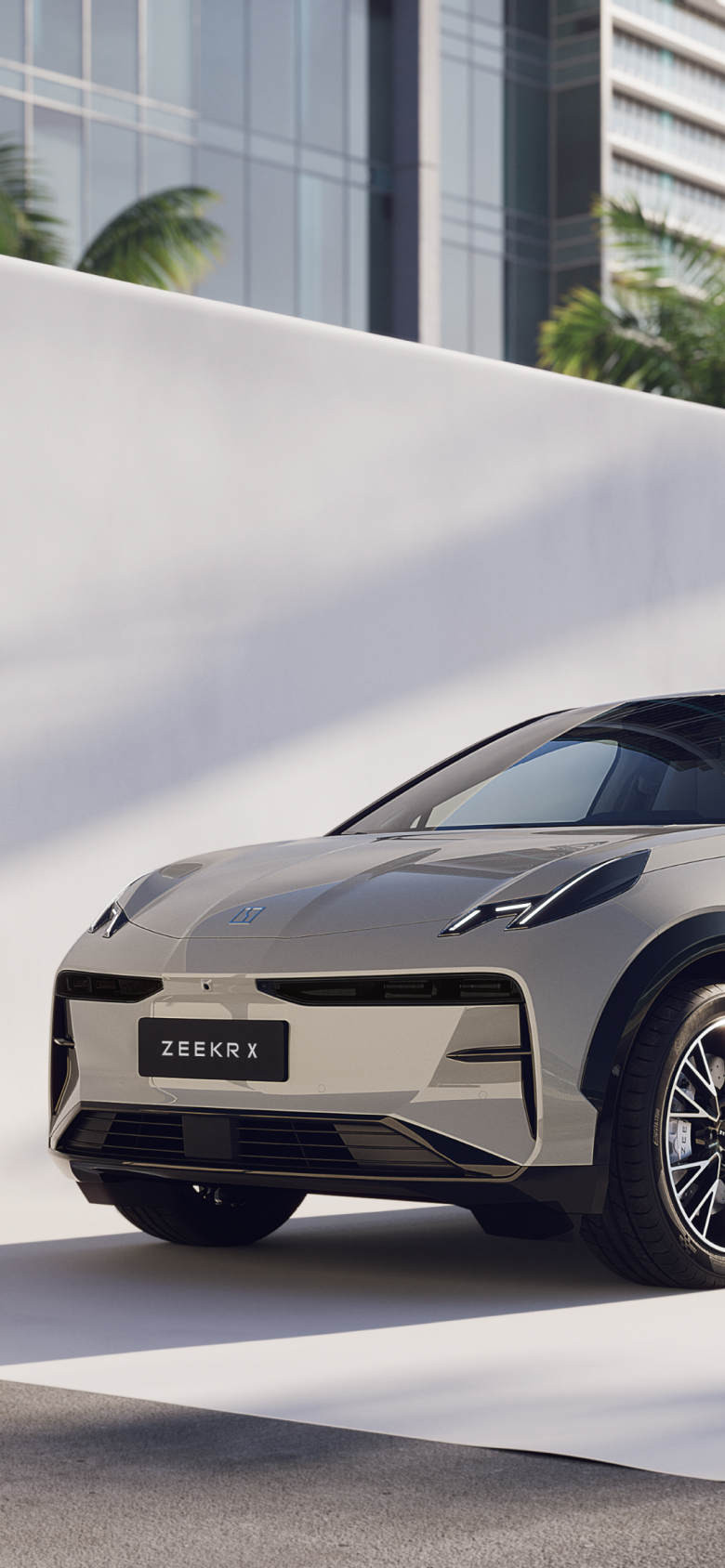A Zeekr X electric SUV in Palace Beige, featuring a sleek aerodynamic design, black roof accents, and parked in a modern urban setting.